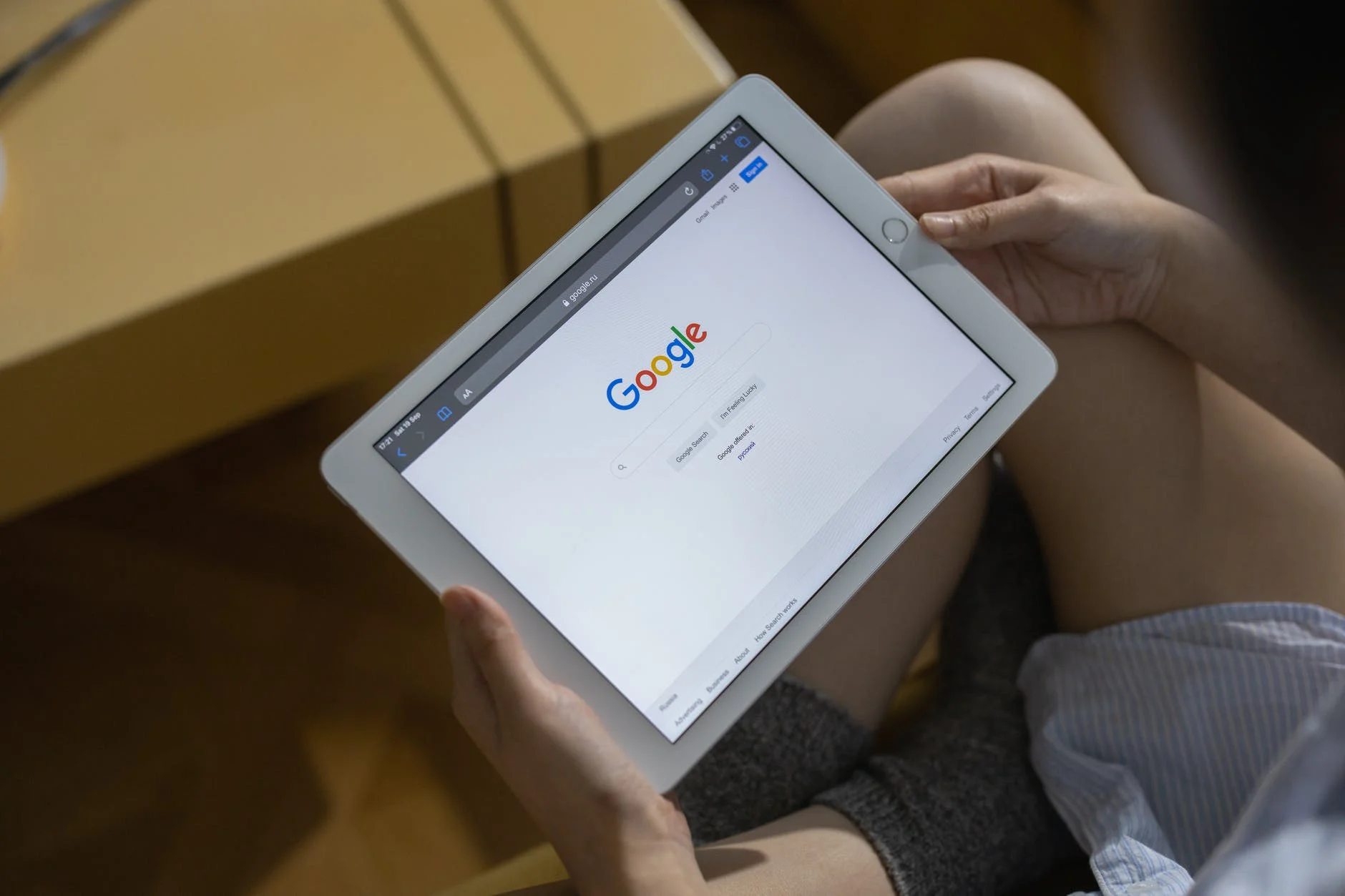 A person holding white ipad mini